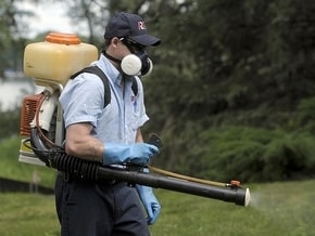 Nick Heiser of Rose Pest Control tackles mosquitoes as fears grow that this will be a bad season with all the unattended properties in the area. (Charles V. Tines / The Detroit News)